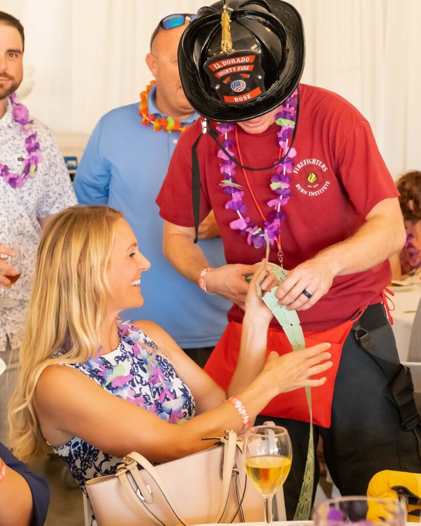 Firefighter giving raffle tickets to woman