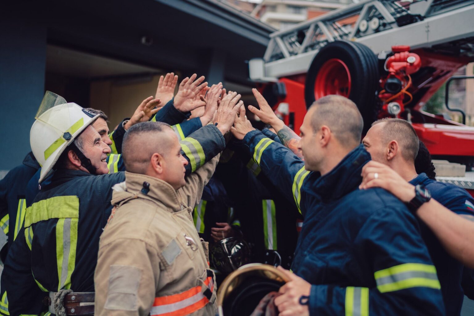 Group of firefighters with hands in middle